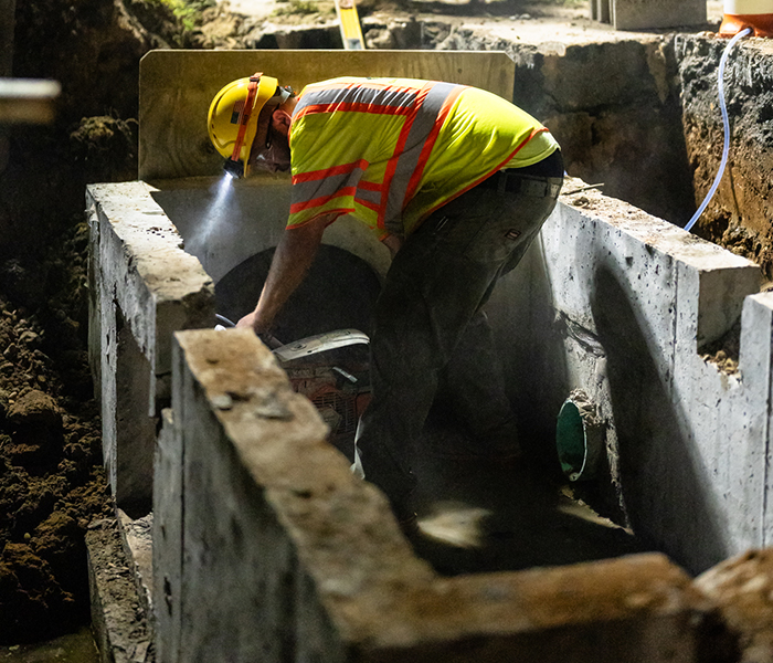 A Earle construction worker installs trench box into a heavy civil trench. NJ.