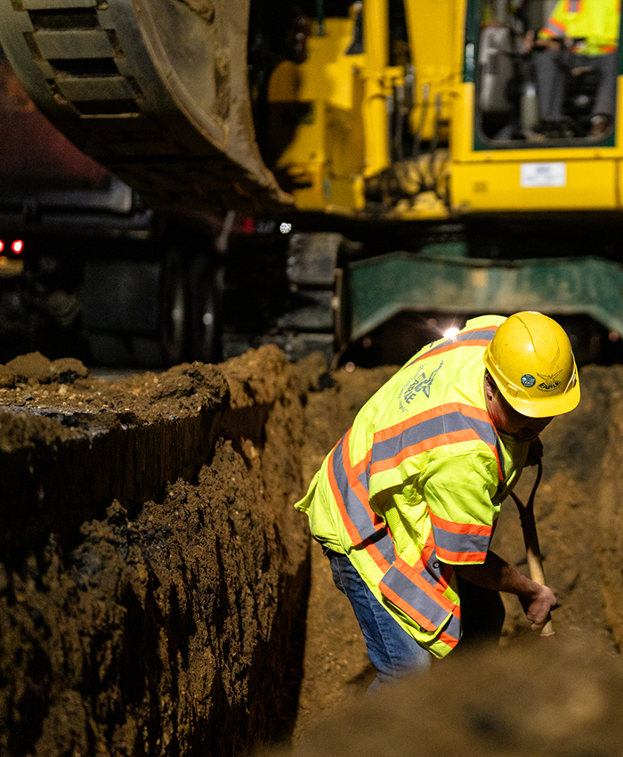 An Earle team member digs in a heavy civil trench on a NJ construction site.
