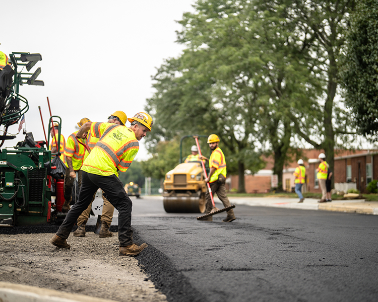 Earle employees smooth over fresh asphalt in New Jersey