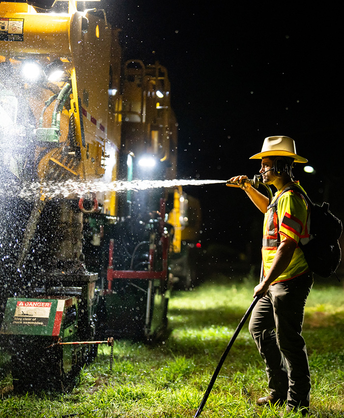 Earle employee uses power wash to spray a truck meant for heavy civil construction in New Jersey